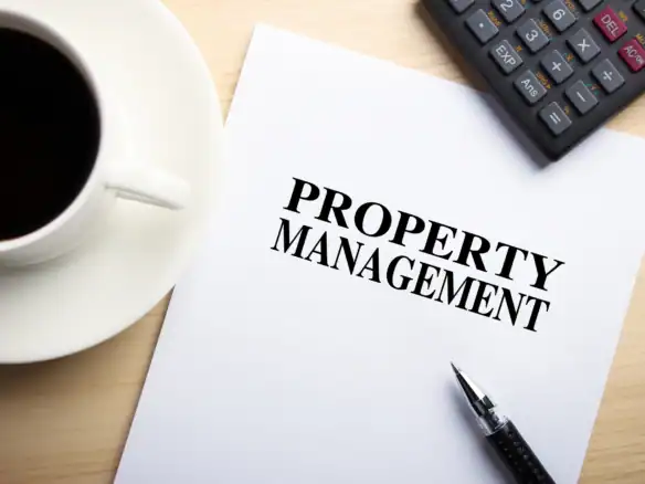 Property management office concept featuring document and financial planning tools workspace